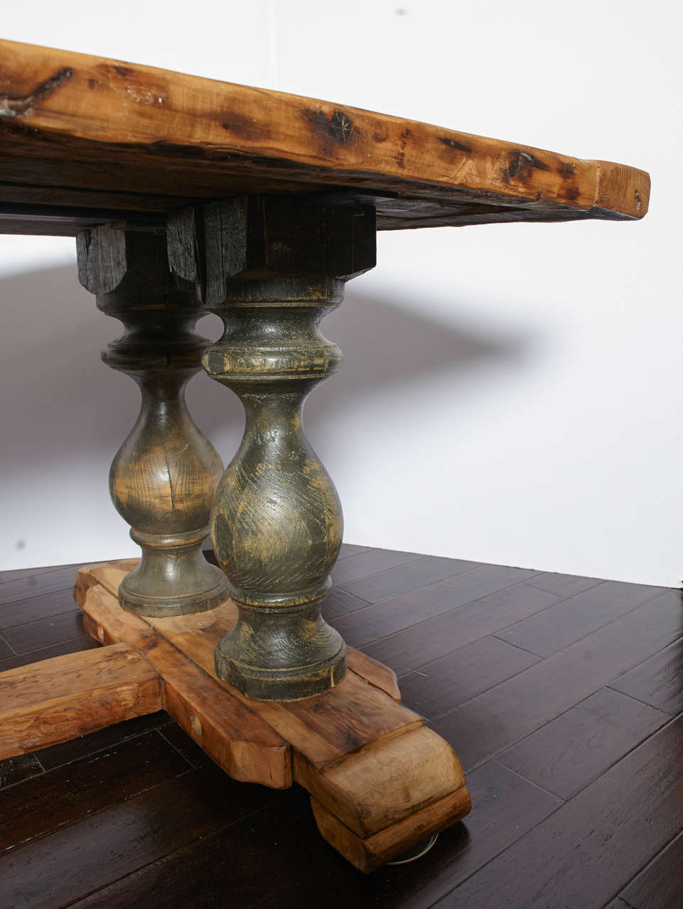 17th century style large reclaimed wood table with dark green baluster shaped legs and stretcher base.